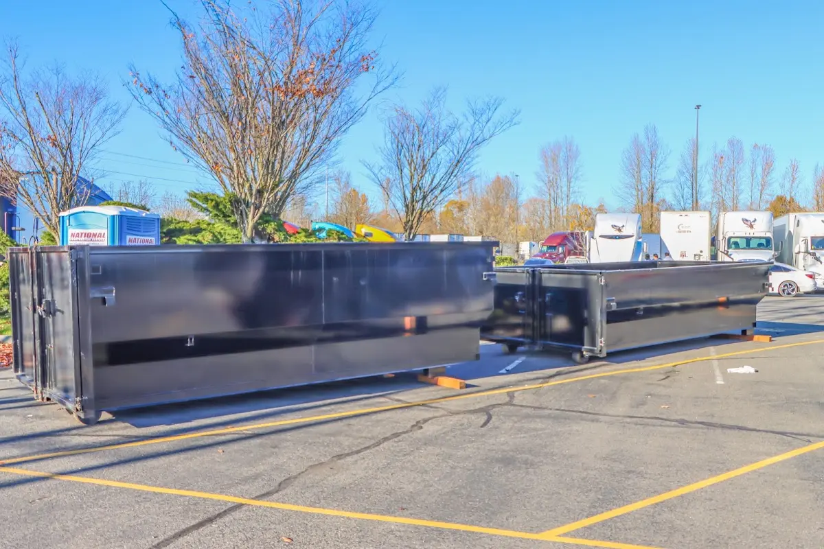 Professional dumpster rental service with roll-off container on residential driveway in Goldenrod